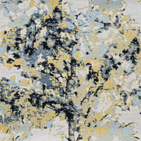 A close-up of a shimmering fabric with a tree motif in gold and pale blue