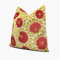 Side view of Suzani floral throw pillow cushion in coral red and green