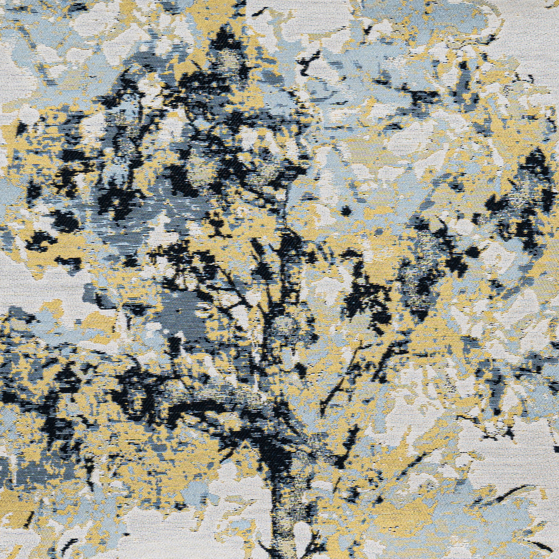 A close-up of a shimmering fabric with a tree motif in gold and pale blue